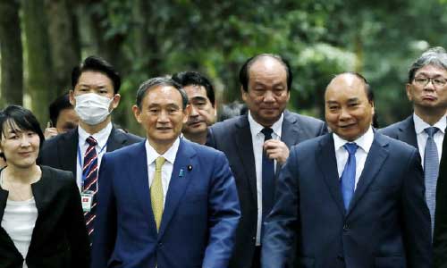Japan, Vietnam agree to boost defense ties, resume flights